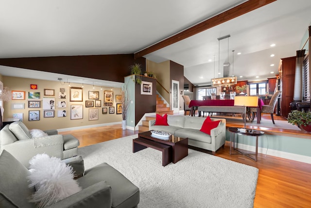 living room featuring lofted ceiling with beams and light hardwood / wood-style floors