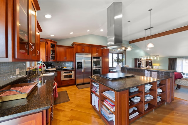 kitchen with pendant lighting, island range hood, sink, a center island, and stainless steel appliances