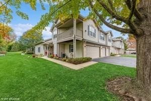 exterior space featuring a garage and a lawn