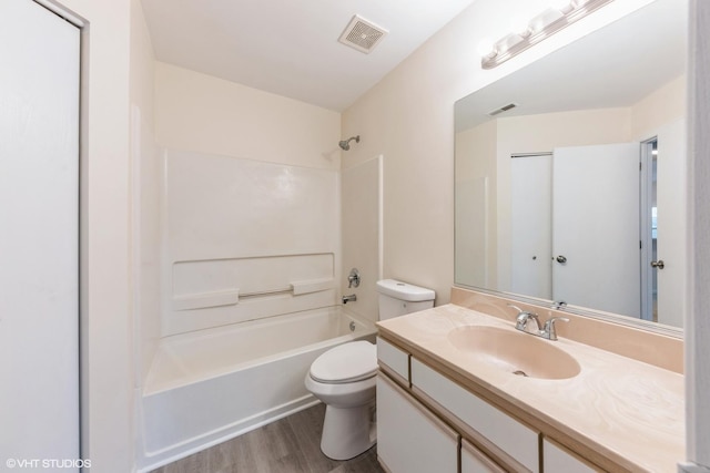 full bathroom with vanity, wood-type flooring, bathtub / shower combination, and toilet