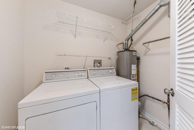 clothes washing area with washing machine and clothes dryer and gas water heater