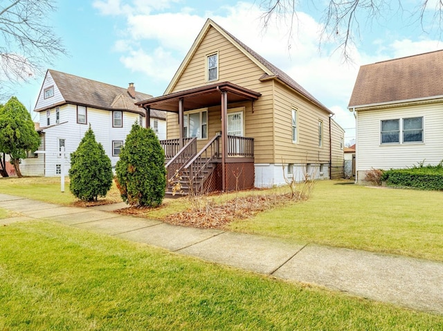 bungalow-style home featuring covered porch and a front lawn