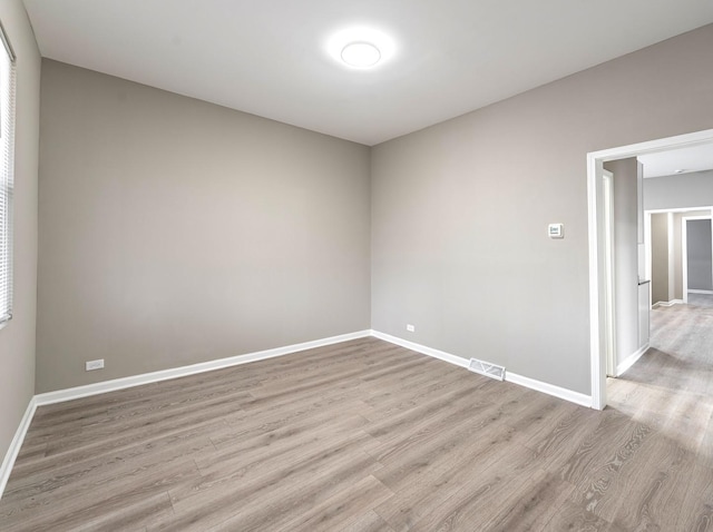 empty room with light hardwood / wood-style flooring