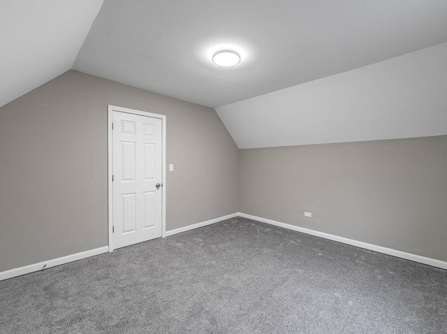 additional living space with lofted ceiling and dark carpet