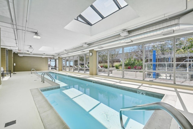 view of swimming pool featuring a skylight