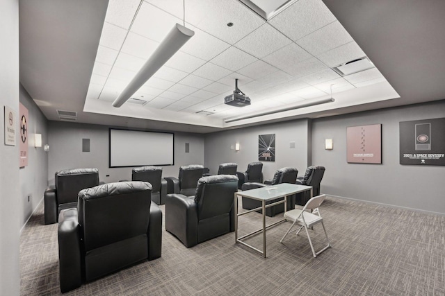 home theater with a raised ceiling and carpet