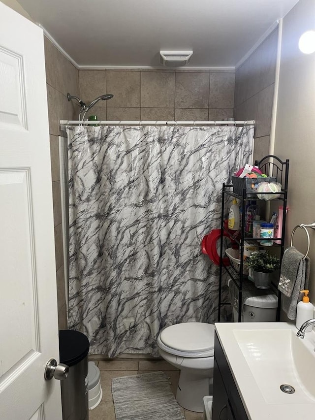 bathroom featuring vanity, toilet, and tile patterned flooring