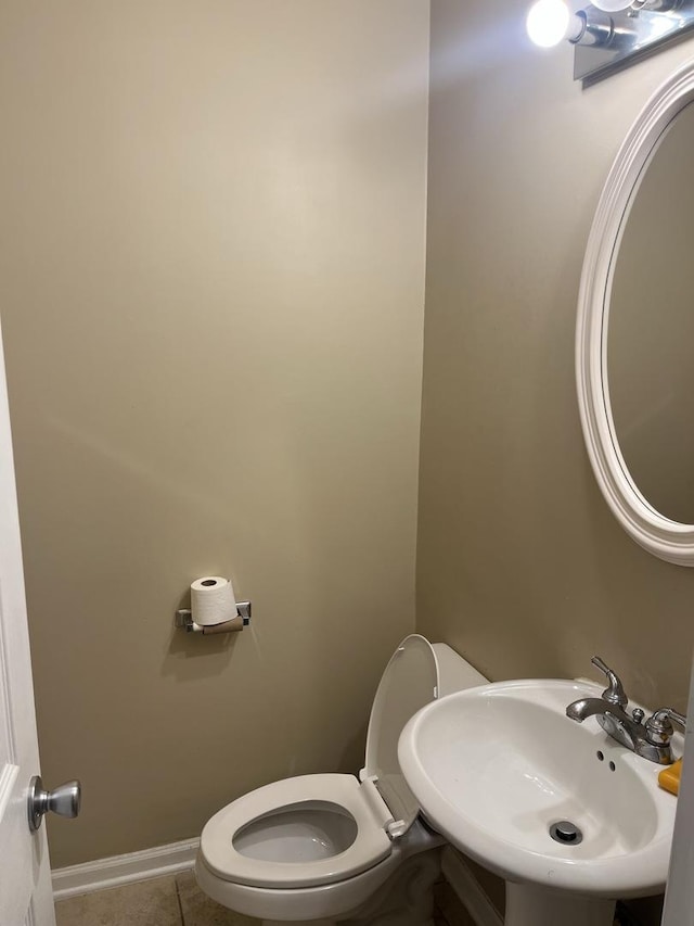 bathroom with sink, tile patterned floors, and toilet