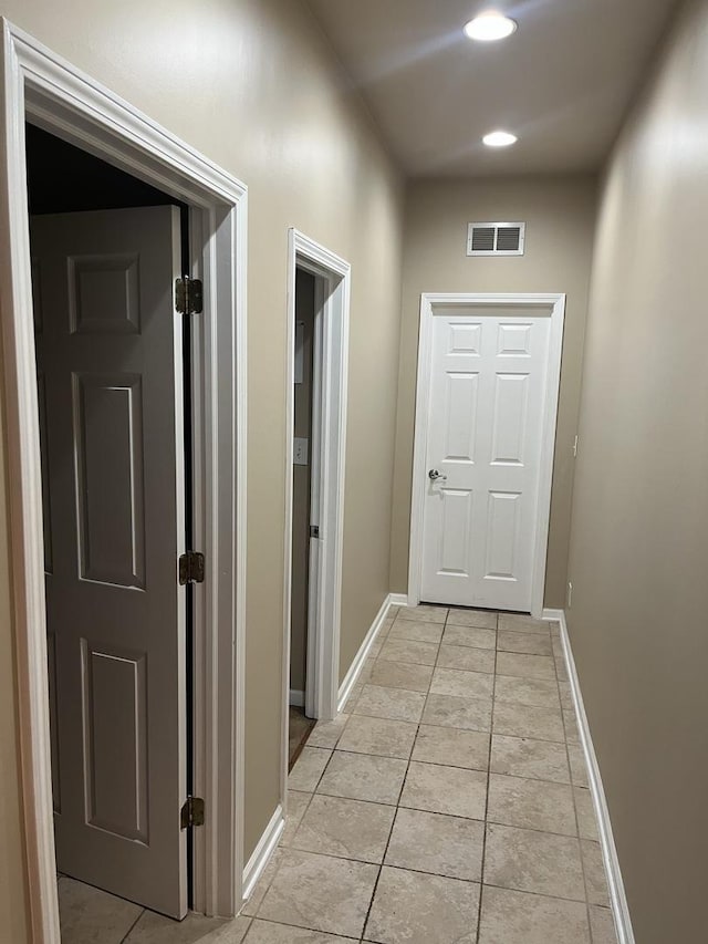 hall with light tile patterned floors