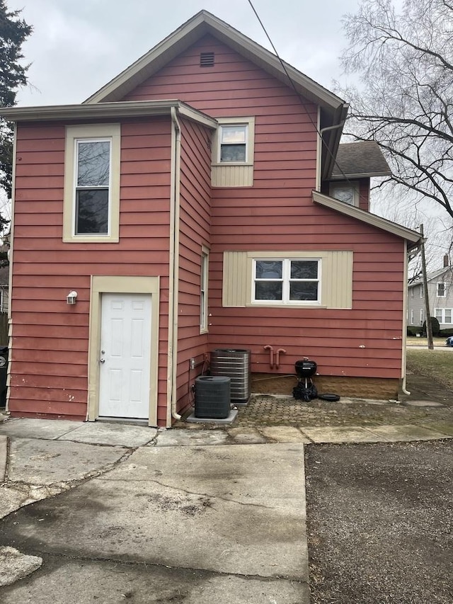 rear view of property with central air condition unit