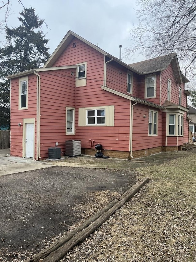 rear view of property featuring central air condition unit