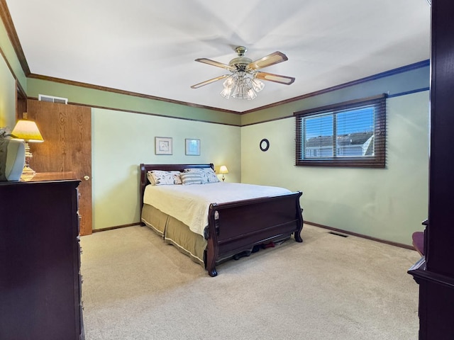 bedroom featuring crown molding, light colored carpet, and ceiling fan