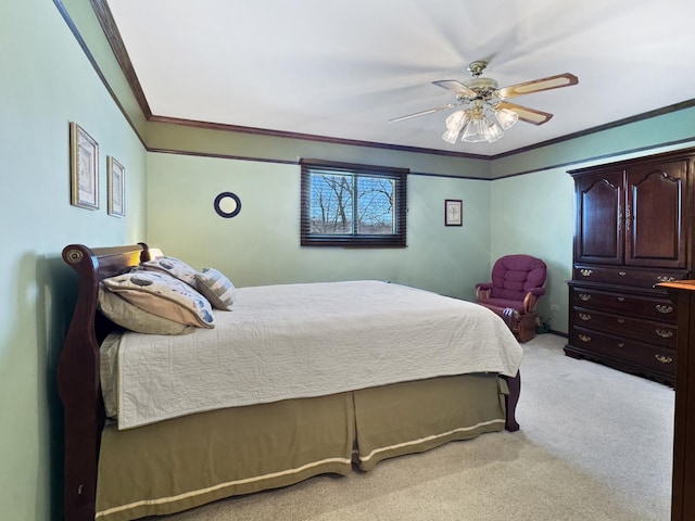 carpeted bedroom featuring ornamental molding and ceiling fan