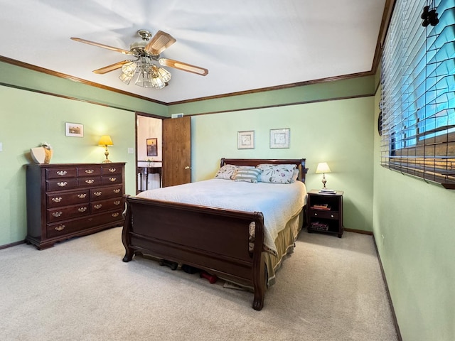 carpeted bedroom featuring ornamental molding and ceiling fan