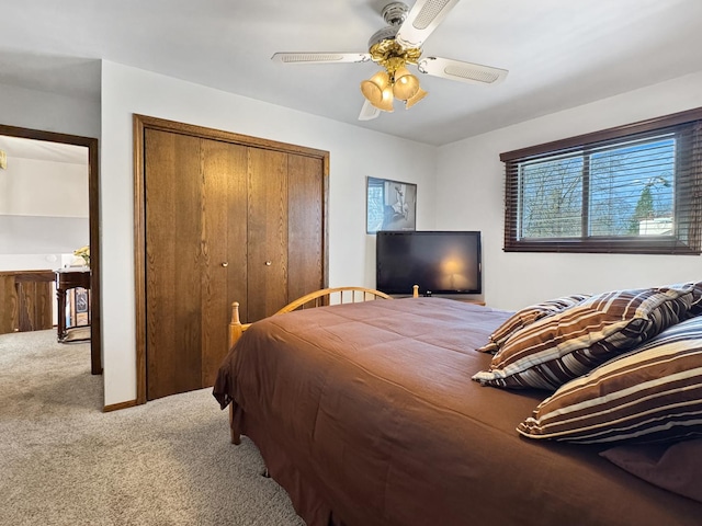 carpeted bedroom featuring a closet and ceiling fan