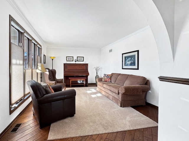 living room featuring dark wood-type flooring and ornamental molding