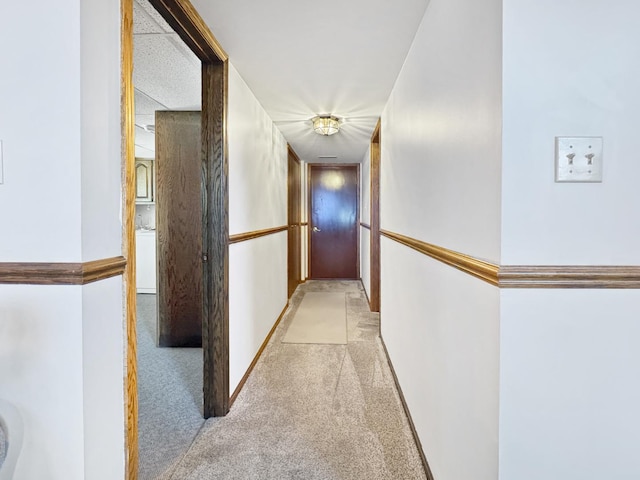 hallway featuring light carpet