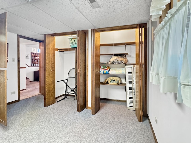 carpeted bedroom with a paneled ceiling