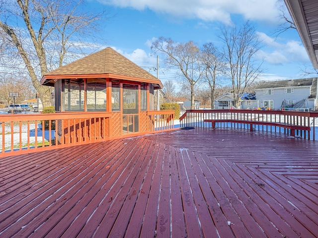 wooden deck with a sunroom