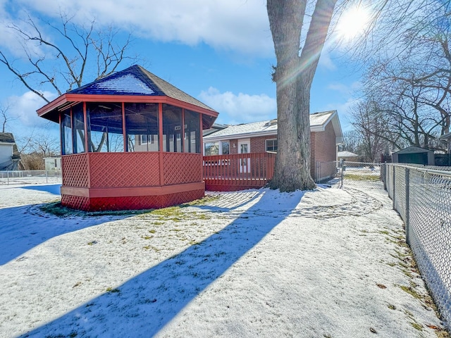 view of snow covered back of property