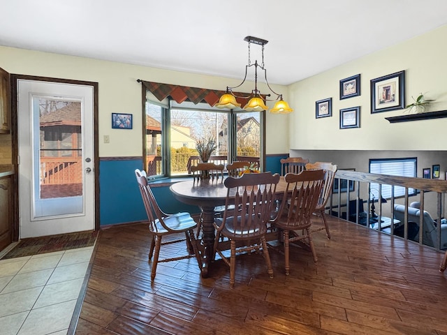 dining space with wood-type flooring