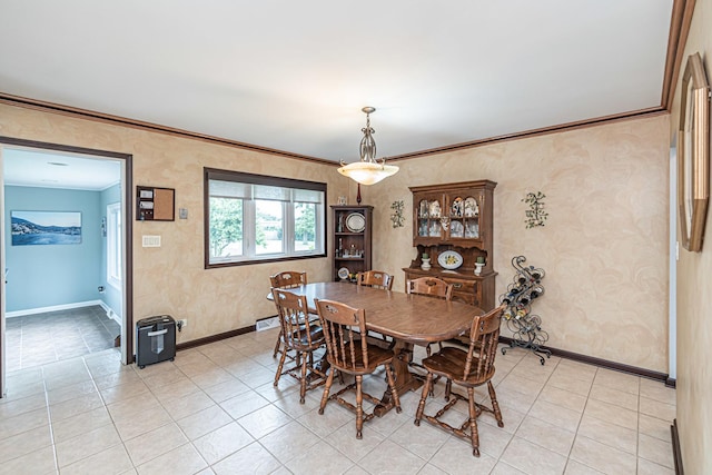 dining area featuring crown molding, baseboards, and light tile patterned floors