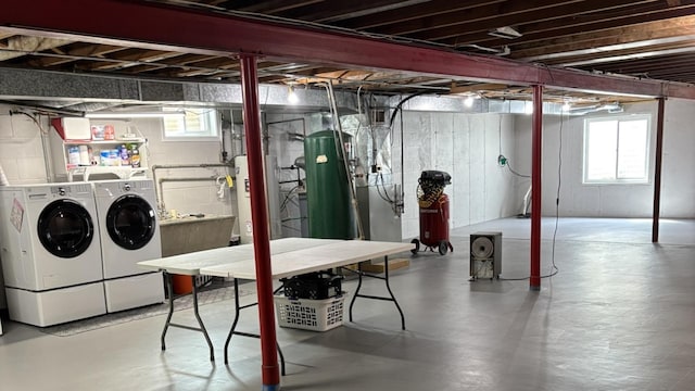 basement featuring washing machine and dryer and water heater