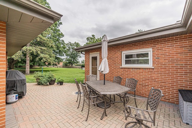 view of patio / terrace with outdoor dining area, a grill, and fence