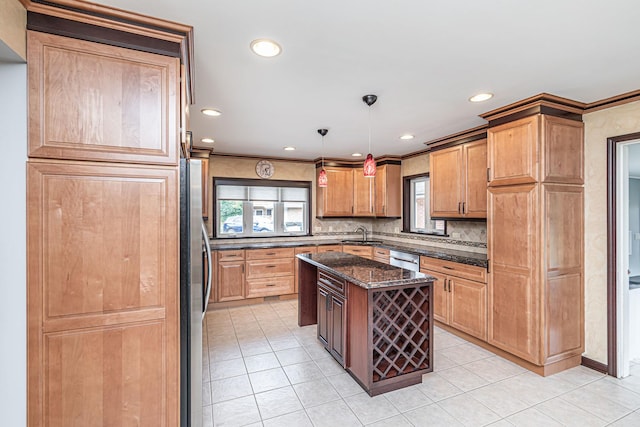 kitchen featuring a sink, freestanding refrigerator, light tile patterned flooring, and tasteful backsplash