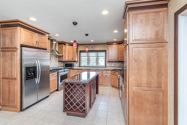 kitchen featuring wall chimney range hood, tasteful backsplash, dark stone countertops, recessed lighting, and appliances with stainless steel finishes
