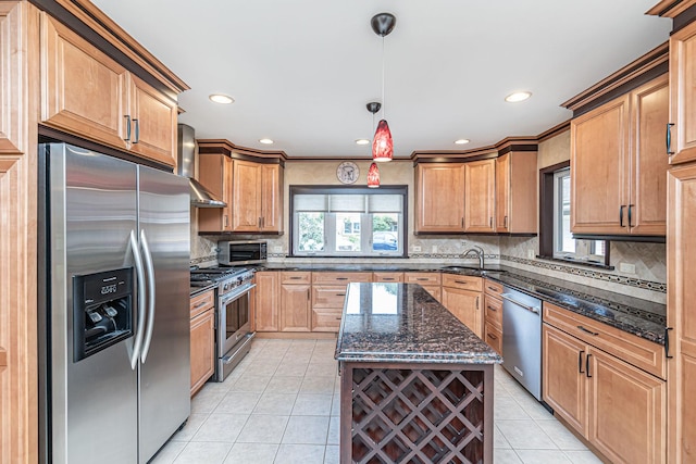 kitchen featuring light tile patterned floors, dark stone countertops, a sink, wall chimney exhaust hood, and appliances with stainless steel finishes