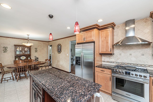 kitchen with wall chimney exhaust hood, stainless steel appliances, tasteful backsplash, and light tile patterned flooring