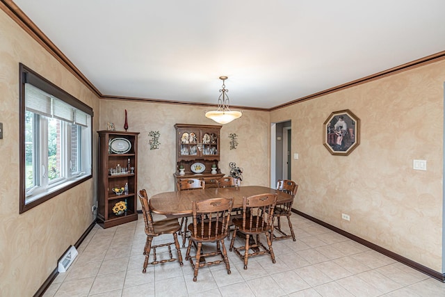 dining room featuring baseboards, ornamental molding, visible vents, and light tile patterned flooring