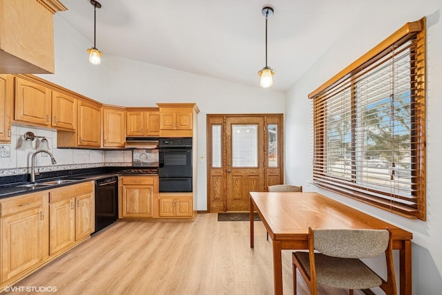 kitchen with pendant lighting, black dishwasher, a warming drawer, light wood-style flooring, and vaulted ceiling