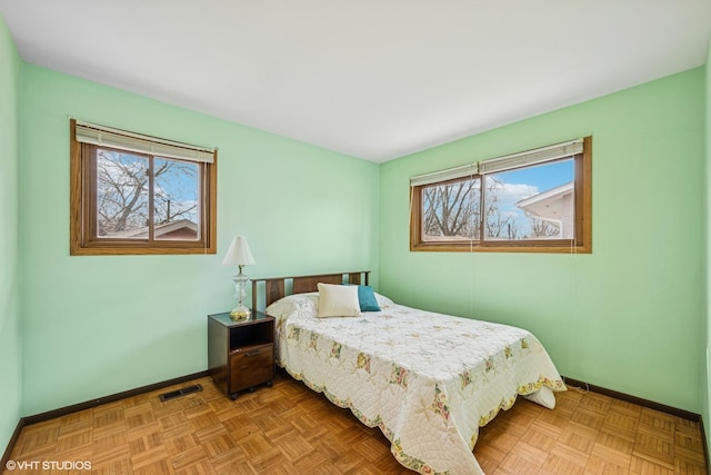 bedroom with visible vents and baseboards