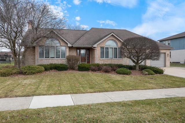 view of front of property with a garage and a front lawn