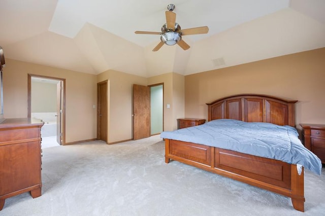 bedroom featuring lofted ceiling, light colored carpet, connected bathroom, and ceiling fan