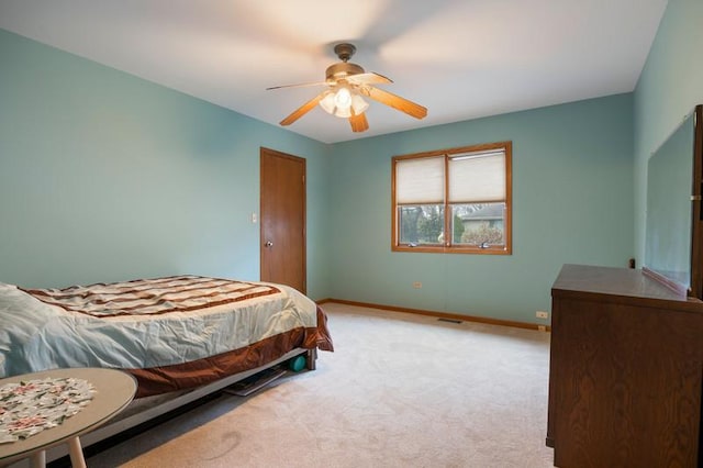 bedroom featuring light colored carpet and ceiling fan