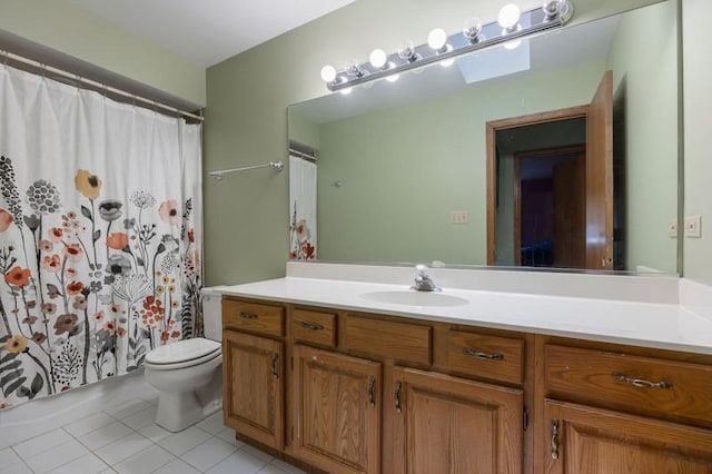 bathroom featuring vanity, tile patterned floors, and toilet