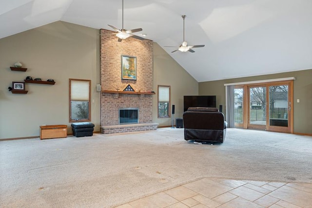 unfurnished living room with ceiling fan, a brick fireplace, light colored carpet, and high vaulted ceiling