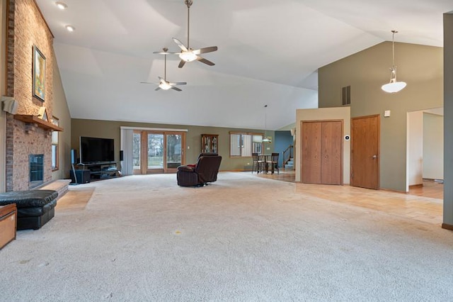 unfurnished living room with light carpet, a fireplace, and high vaulted ceiling