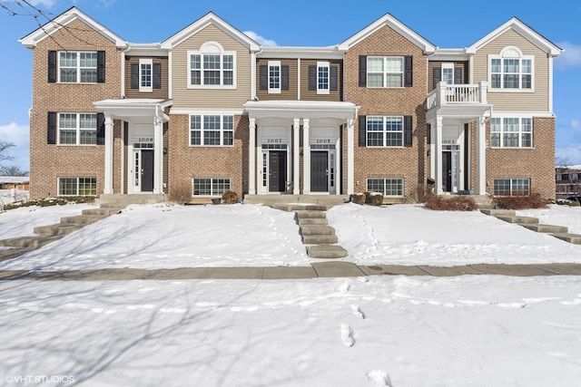 townhome / multi-family property with brick siding