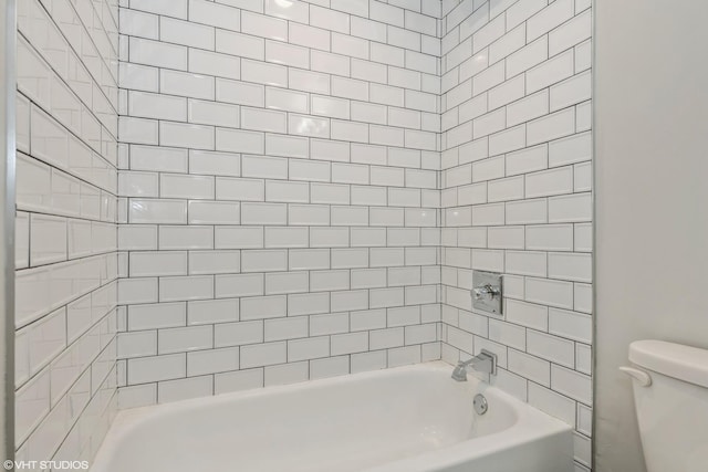 bathroom featuring toilet and  shower combination