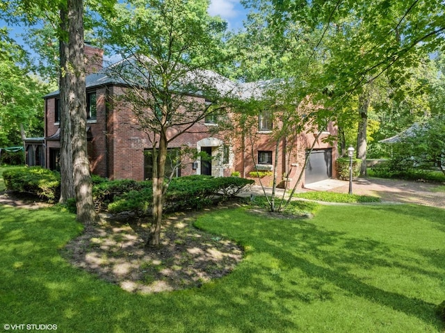 view of front of home with a garage and a front lawn