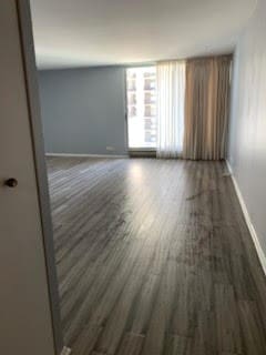 spare room featuring dark wood-type flooring