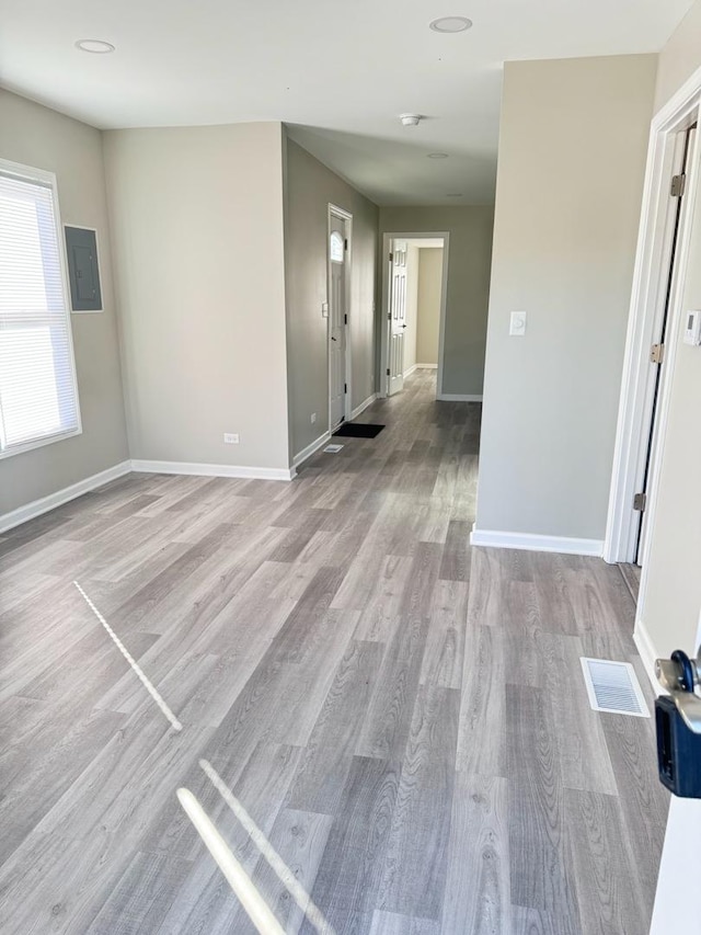 unfurnished room featuring light hardwood / wood-style flooring and electric panel