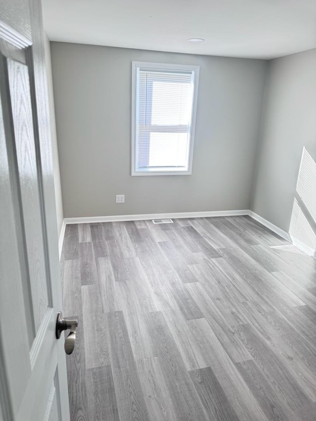 unfurnished room with light hardwood / wood-style floors