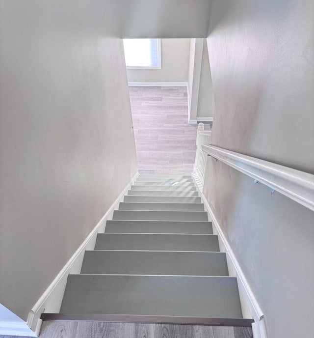 staircase with hardwood / wood-style flooring