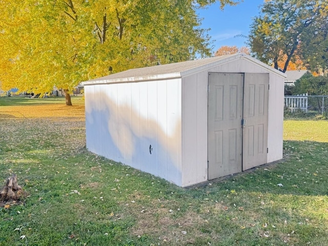 view of outbuilding featuring a lawn