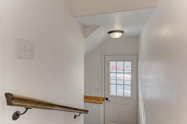 doorway to outside with lofted ceiling